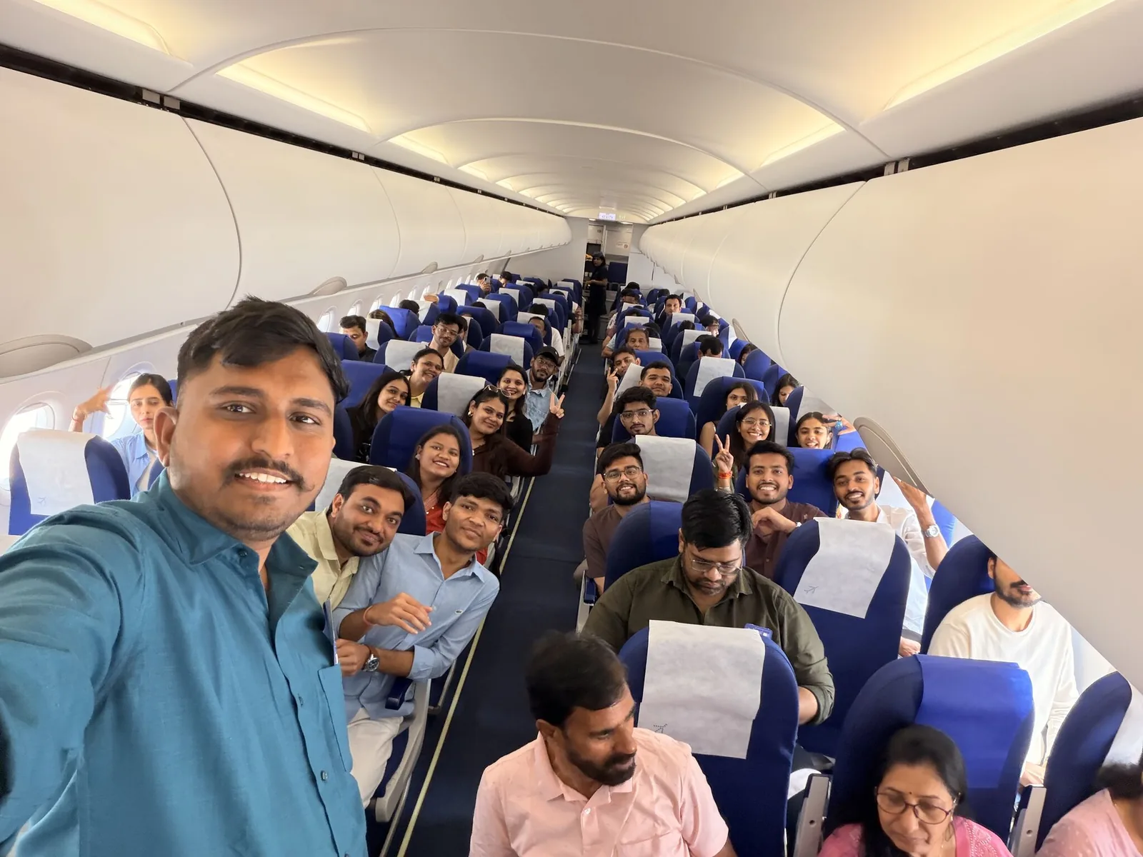 Sharedpro colleagues taking a group selfie aboard the flight for their Goa offsite