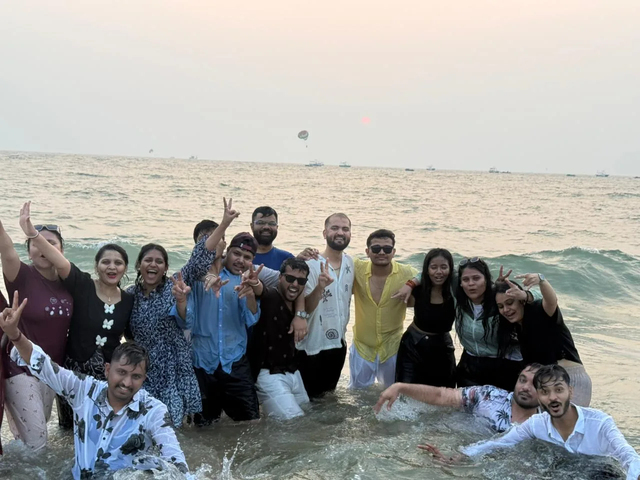 Sharedpro team together in the waves at the beach in Goa