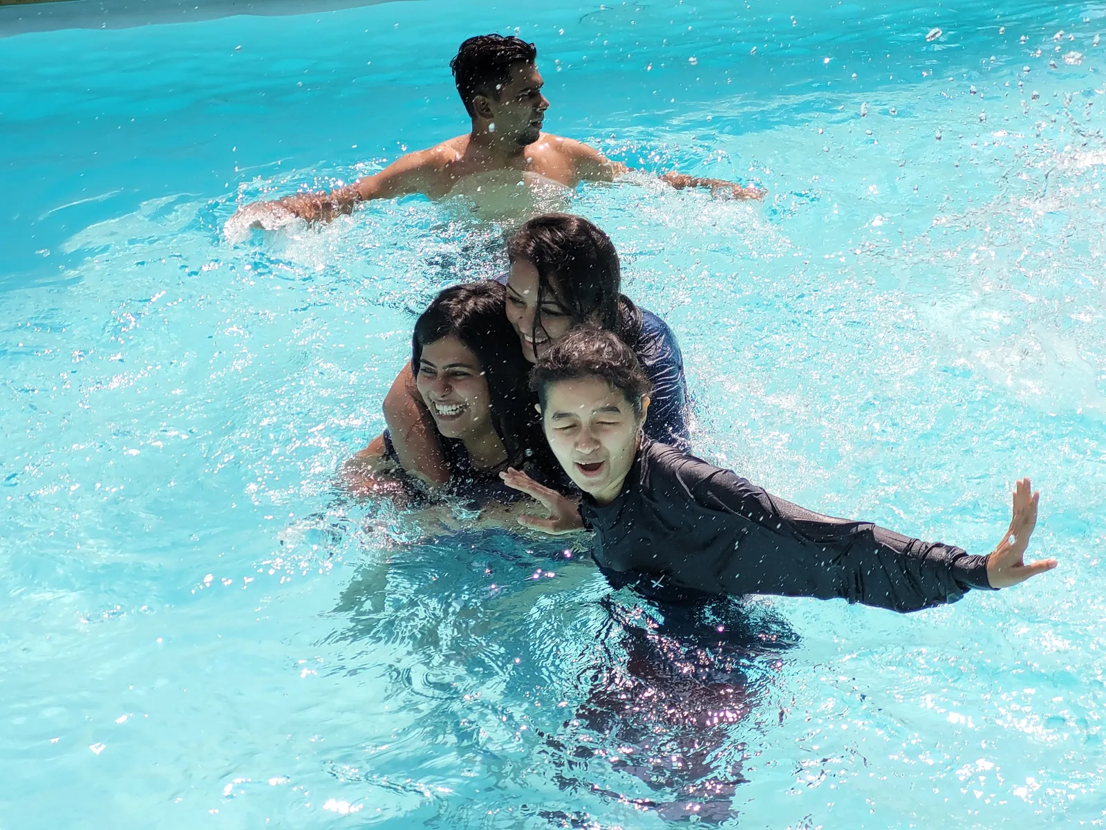 Sharedpro colleagues enjoying time together in the swimming pool at the Lonavala offsite