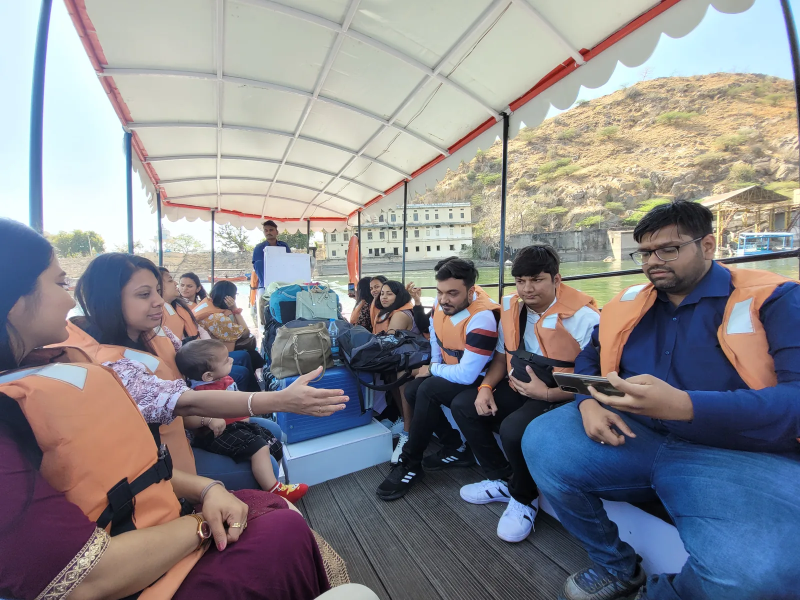 Sharedpro colleagues wearing life jackets on a boat during the Udaipur offsite